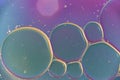 Colorful background with plastic oil bubbles on water surface with blue, gold, green, purple pastel colour Royalty Free Stock Photo