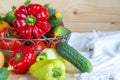 Colorful background with vegetables harvest in wicker basket on wooden background covered with white linen fabric with Royalty Free Stock Photo