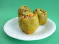 Colorful baked with yoghurt, stuffed peppers with rice and minced meat. Front view. Royalty Free Stock Photo