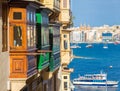 Colorful balconies of Valletta with tourist boat - Malta