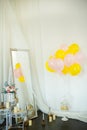 Colorful ballons with flowers on the white wall