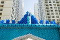 Colorful balloons against apartment buildings and blue sky on background. Concept of outdoor celebration activities or event of ap Royalty Free Stock Photo