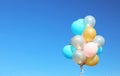 Colorful balloons against clear blue sky on sunny day