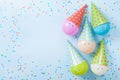 Colorful balloons and confetti on blue table top view. Birthday or party background. Flat lay. Greeting card.