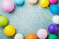 Colorful balloons and confetti on turquoise table top view. Birthday, holiday or party background. Flat lay style. Royalty Free Stock Photo