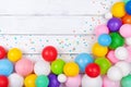 Colorful balloons and confetti on white table top view. Festive or party background. Flat lay. Birthday greeting card Royalty Free Stock Photo