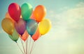 Colorful balloons float in sky. Bunch of multicolored balloons. Retro vintage effect. Ideal for birthday party celebration.
