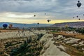 Colorful balloons fly over Cappadocia. Below is a gorge with white slopes Royalty Free Stock Photo