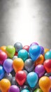 Colorful balloons hanging on grey wall. Party and celebration concept.