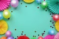 Colorful balloons and paper flowers on blue table top view. Festive or party background. Flat lay style. Copy space for text. Birt