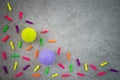 Colorful balloons and rubber balls on concrete background