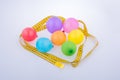 Colorful balloons surrounded by measuring tape with celebration Royalty Free Stock Photo