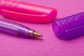 Colorful ballpoint pens on color background