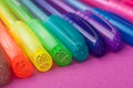 Colorful ballpoint pens on color background