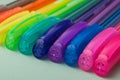 Colorful ballpoint pens on color background