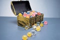 Colorful balls spilling out of a treasure chest with bokeh Royalty Free Stock Photo