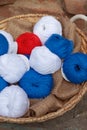 Colorful balls of wool and cotton yarn in a basket on the rustic background Royalty Free Stock Photo