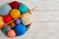 Colorful balls of wool and crochet on white wooden background Royalty Free Stock Photo
