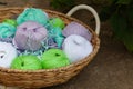 Colorful balls of wool yarn in a basket on the rustic background Royalty Free Stock Photo
