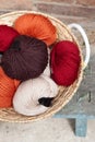 Colorful balls of wool yarn in a basket on the rustic background Royalty Free Stock Photo