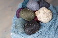 Colorful balls of wool yarn in a basket on the rustic background Royalty Free Stock Photo