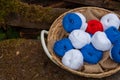 Colorful balls of wool and cotton yarn in a basket on the rustic background Royalty Free Stock Photo