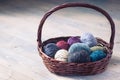 Colorful balls of wool yarn in a basket on the rustic background Royalty Free Stock Photo