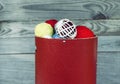 Colorful balls of yarn in round box on wooden wall background. Royalty Free Stock Photo