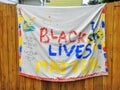 Colorful Banner Draped Across A Wood Fence In A Urban Neighborhood