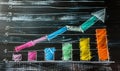 Colorful Bar Graph with Rising Arrow Indicating Growth, Progress and Success on a Blackboard, Symbolizing Business Analysis Royalty Free Stock Photo