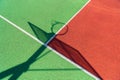 Colorful basketball outdoor court. Shadow of the rack with shield and basketball ring