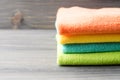 Colorful bath towels on wooden background closeup