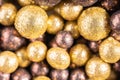 Colorful baubles decoration. Golden and brown glittering bubbles, macro. Balls textured with glittering paillettes. Event concept Royalty Free Stock Photo