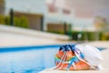 Colorful beach bag, glass of juice, straw hat and airplane model in female hand on summer vacation Royalty Free Stock Photo