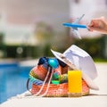 Colorful beach bag, glass of juice, straw hat and Royalty Free Stock Photo