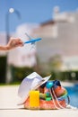 Colorful beach bag, glass of juice, straw hat and Royalty Free Stock Photo