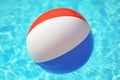 Colorful beach ball floating in swimming pool Royalty Free Stock Photo