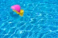 Colorful beach ball in swimming pool water Royalty Free Stock Photo