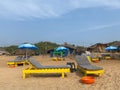 Colorful beach beds outside a deserted beach shack in Candolim