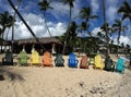 Colorful beach chairs, palm trees, and beautiful sand beach