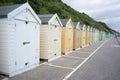 Colorful Beach huts, in beige and white colors, at the boulevard in Bournemouth, Dorset, UK, England on a cloudy day in summer