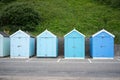 Colorful Beach huts, in blue colors, at the boulevard in Bournemouth, Dorset, UK, England on a cloudy day in summer