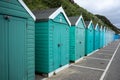 Colorful Beach huts, in green and blue colors, at the boulevard in Bournemouth, Dorset, UK, England on a cloudy day in summer