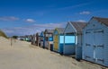 Colorful beach huts on a sandy beach. Royalty Free Stock Photo