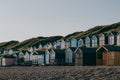 Colorful beach huts during sunset by the sea, holiday and travel concept Royalty Free Stock Photo