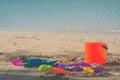 Colorful beach toys or children toys on sand beach with seascape view in the background. Royalty Free Stock Photo