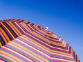 Colorful beach umbrella against the blue sky. Striped texture Royalty Free Stock Photo