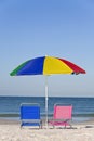 Colorful Beach Umbrella, Pink & Blue Deckchairs Royalty Free Stock Photo