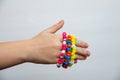 Colorful bead bracelet hand of a young girl