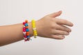 Colorful bead bracelet hand of a young girl